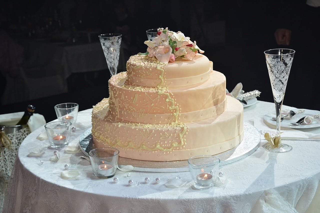 light pink 3 tier cake with Champaign lace wine glasses 