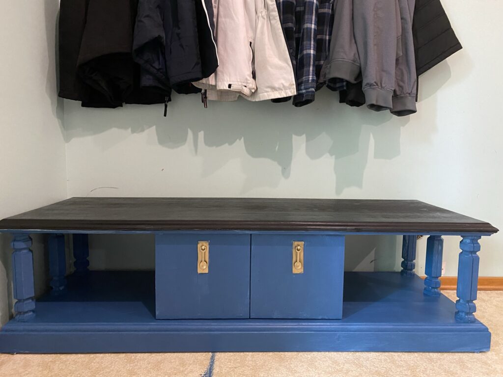 Upcycled TV Stand Turned Into Bench feature image of a blue tv stand with black top under a coat rack
