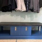 Upcycled TV Stand Turned Into Bench feature image of a blue tv stand with black top under a coat rack