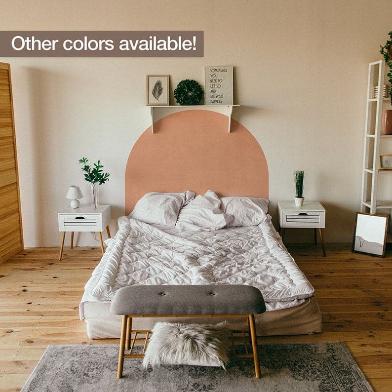 Half moon wall decal in a peach colour. It's pictured above the bed like a headboard in the bed room decor.