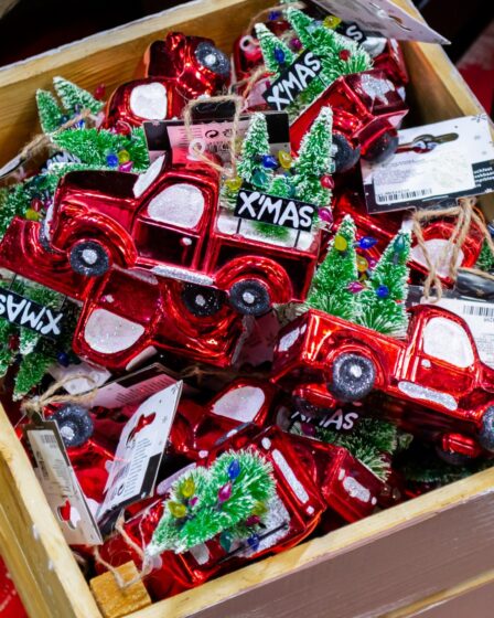 Christmas Red Truck Decor Ideas featured image of a wooden crate filled with red truck ornaments