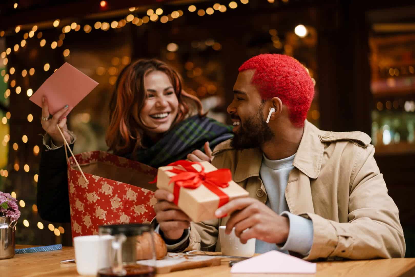 Gift Ideas for a Couple featured image of two people holding a gift