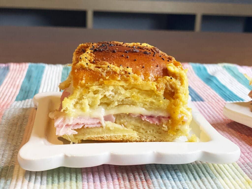 Ham and Swiss Slider Recipe featured image of a single slider on a plate