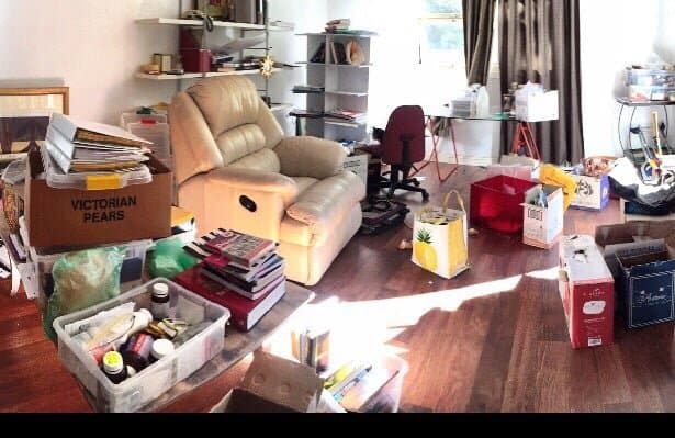 A messy room full of boxes and clutter