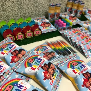 A bunch of snacks on a table with homemade Cocomelon packaging, there's chip bags and drinks