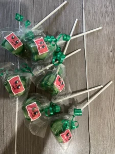 Watermelon cake pops with a cocomelon face