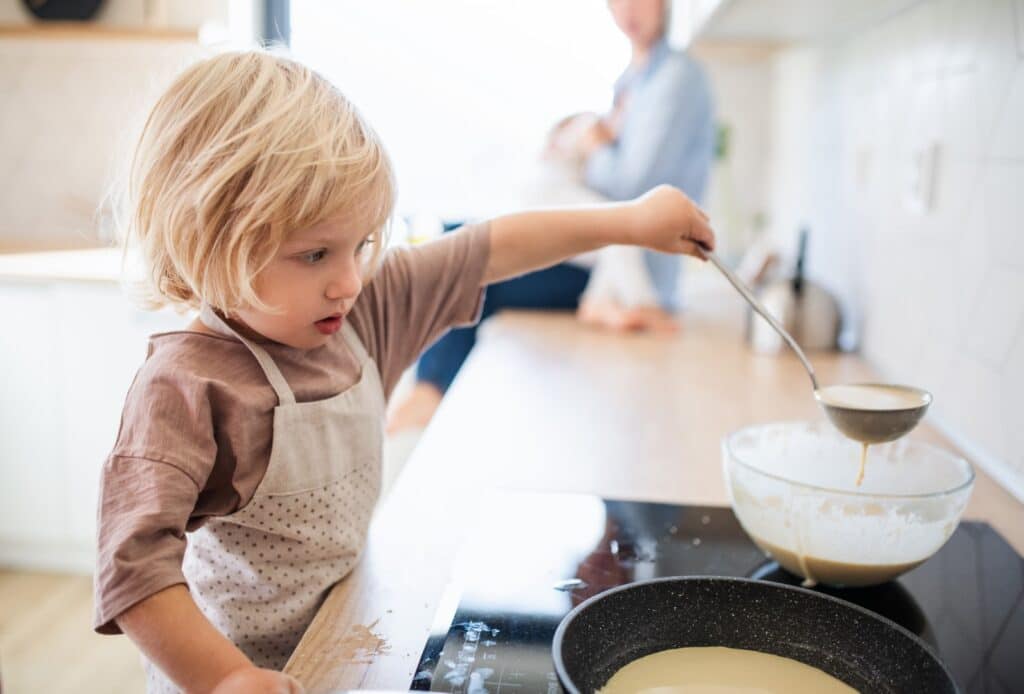 kid helping prepare breakfast