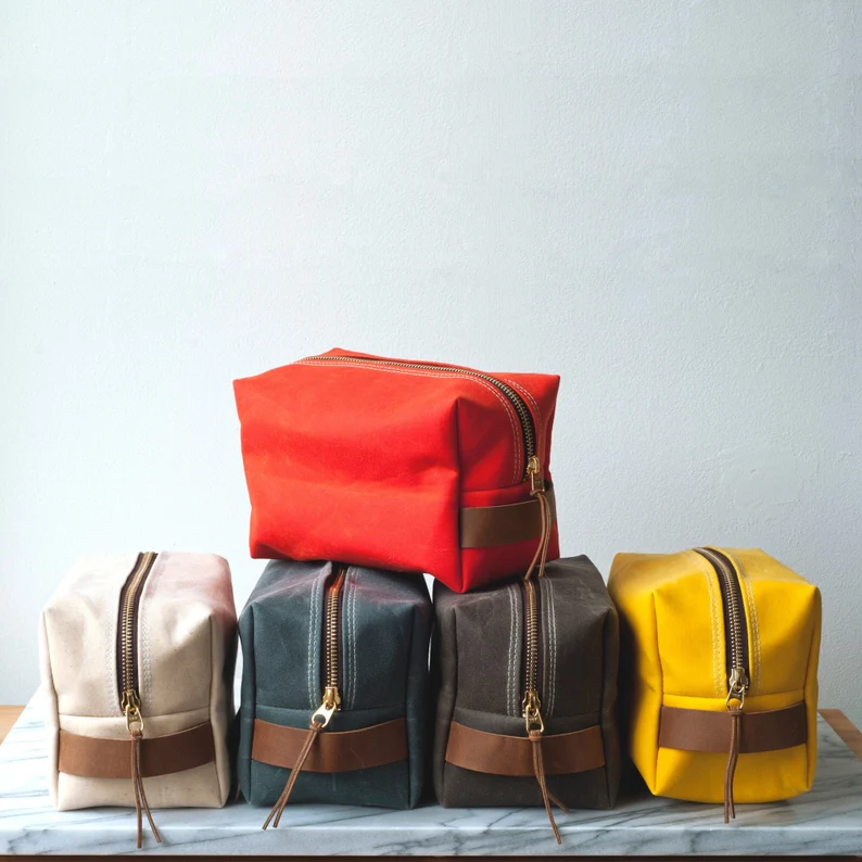 Canvas toiletry bags in red, white, blue, brown, and yellow