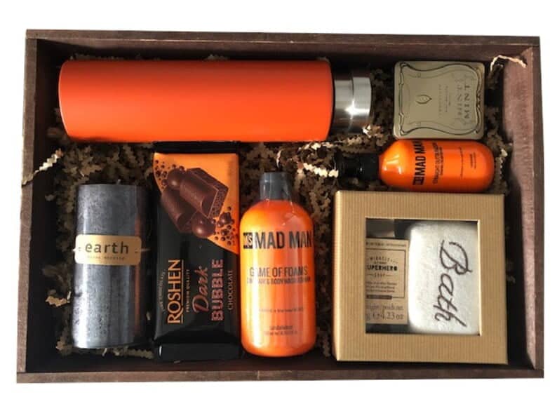 Wreck it crate with a bunch of relaxation goodies inside like a face cloth, personal care items, chocolate, and a water bottle