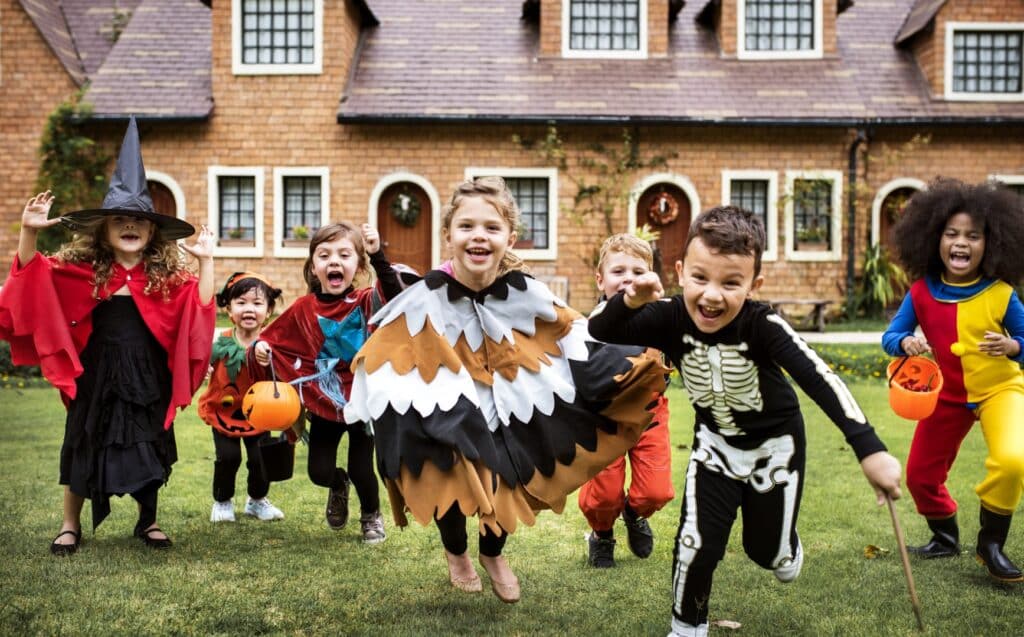 Kids in Halloween costumes attending a Halloween party as an example of trick or treating alternatives