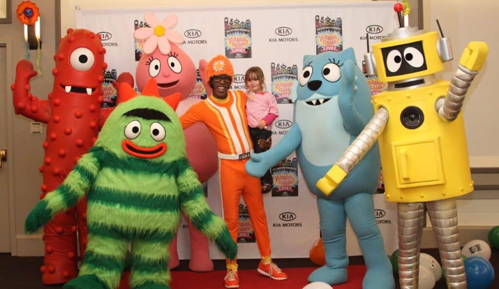 Child with the cast of the show Yo Gabba Gabba.