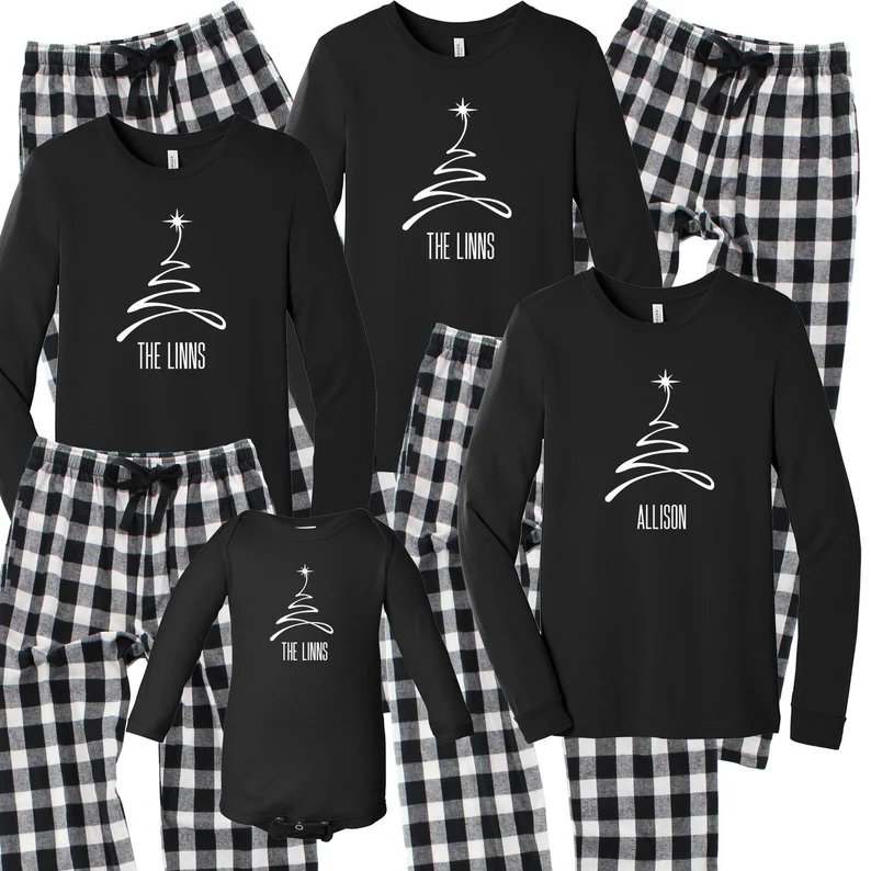 black tops with custom white tree and name with black and white plaid bottoms matching pajamas.