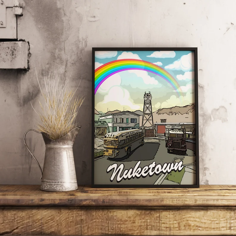 nuketown poster showing rainbow over city in a black frame 