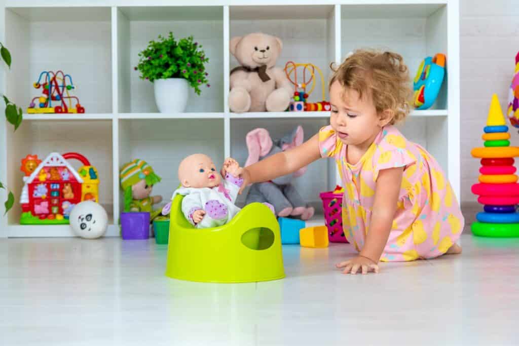 Children sit on the potty in the room.