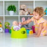 Children sit on the potty in the room.